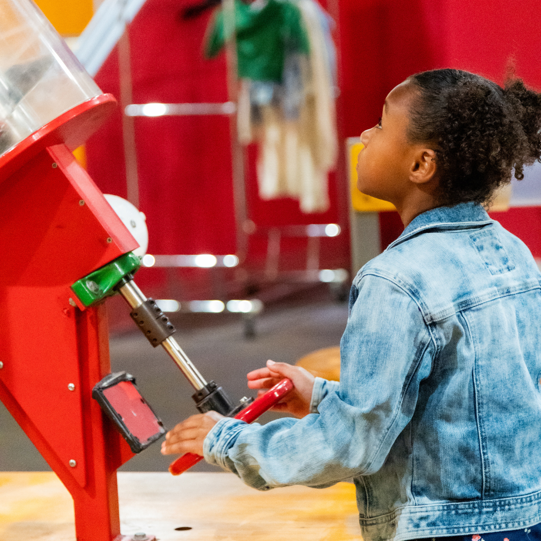 kid playing at ball machine