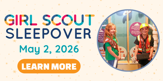 text: girl scout sleepover may 2, 2026 learn more picture of two girl scouts wearing their vest and badges while playing in the construction house