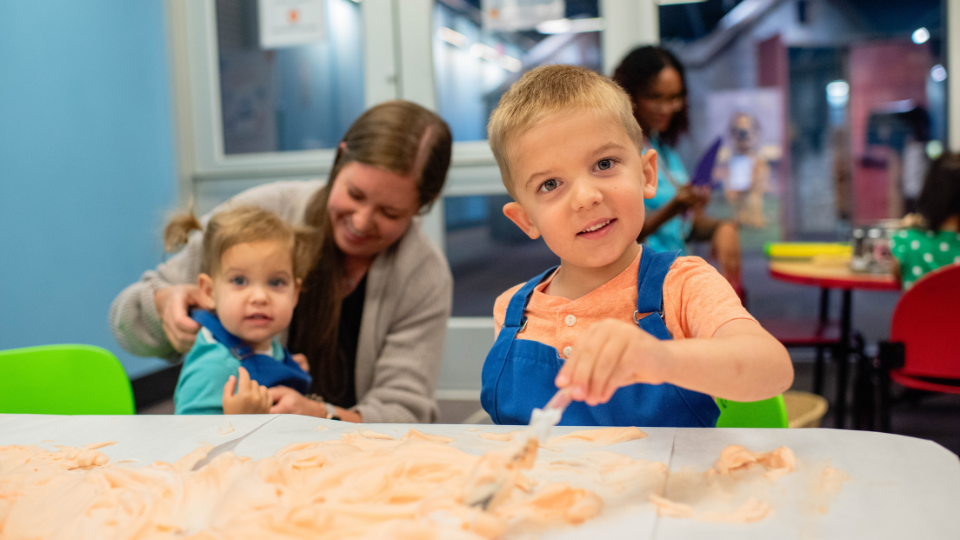 Child playing with shaving cream paint